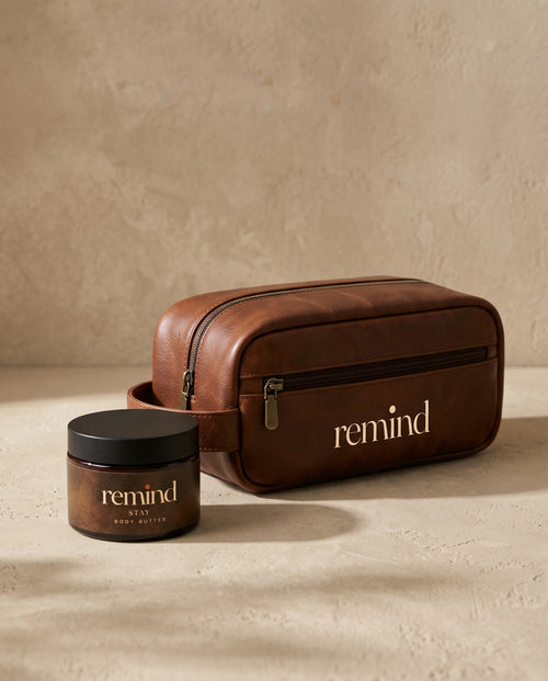 REMIND toiletry bag next to a REMIND body butter jar