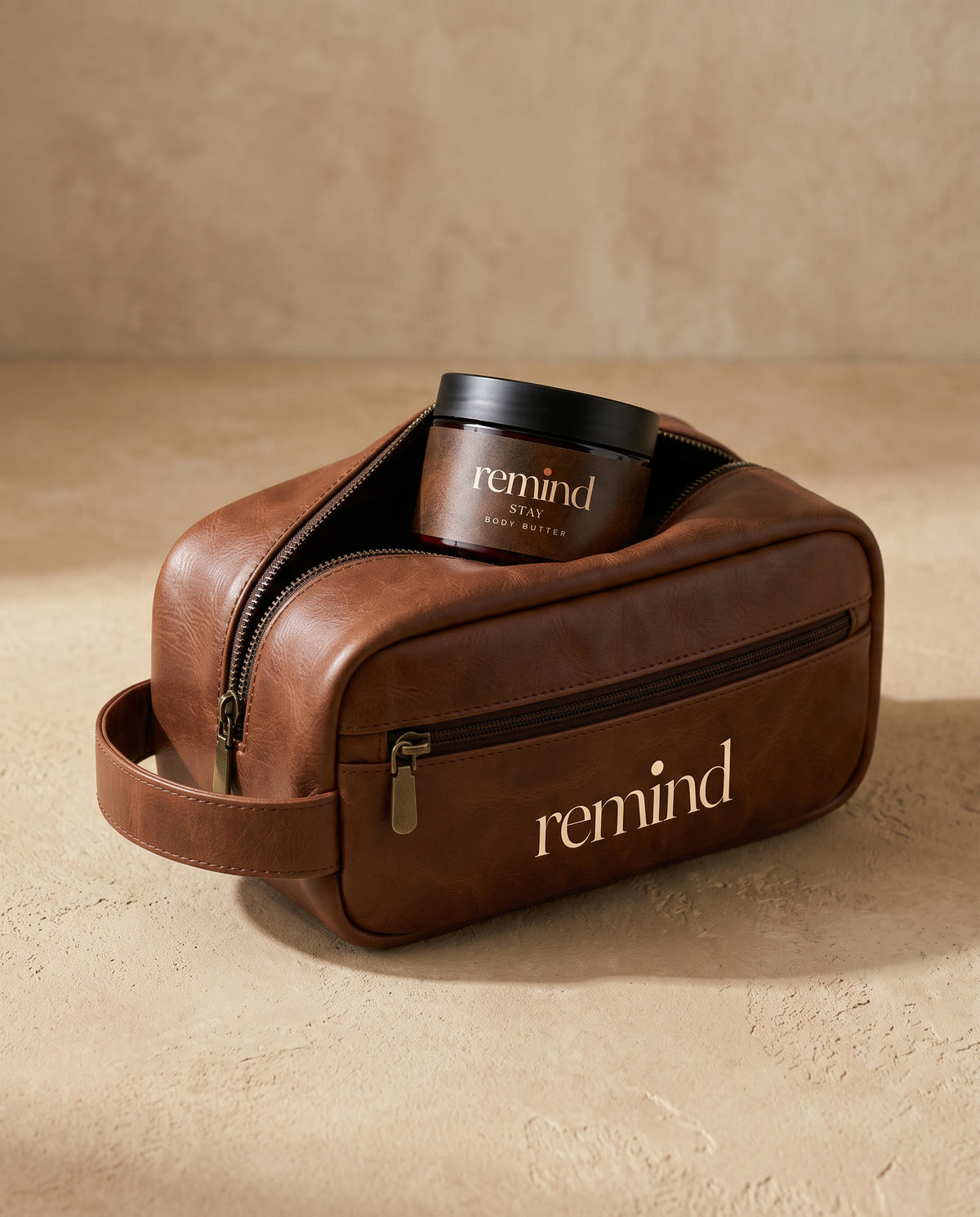 REMIND toiletry bag with the zip open and a REMIND body butter jar inside